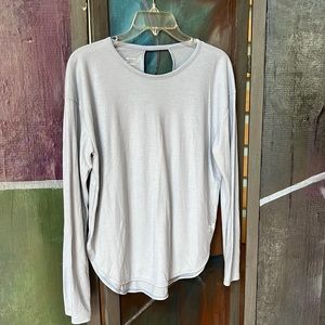 Under Armour light blue heat gear top with 2 cutouts on the back.